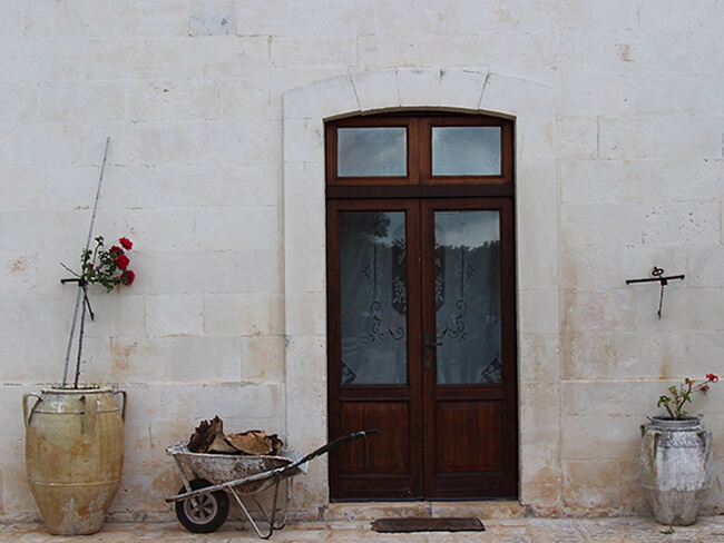 wheelbarrow and door Puglia Italy Carol Ketelson Delectable Destinations Culinary Tours