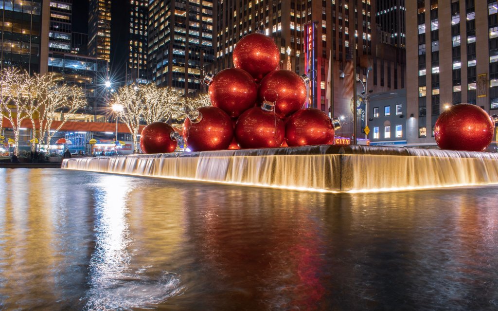 Giant red Christmas ornaments on top of fountain in New York City