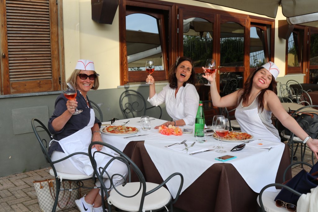 women enjoying wine on culinary tour in Italy