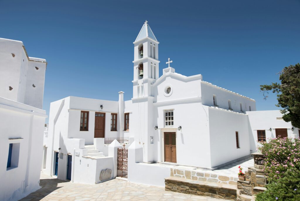 White church on a Greek island against a clear blue sky