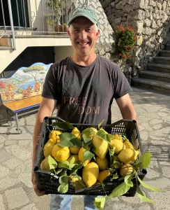 Man holding a basket of Amalfi Coast lemons