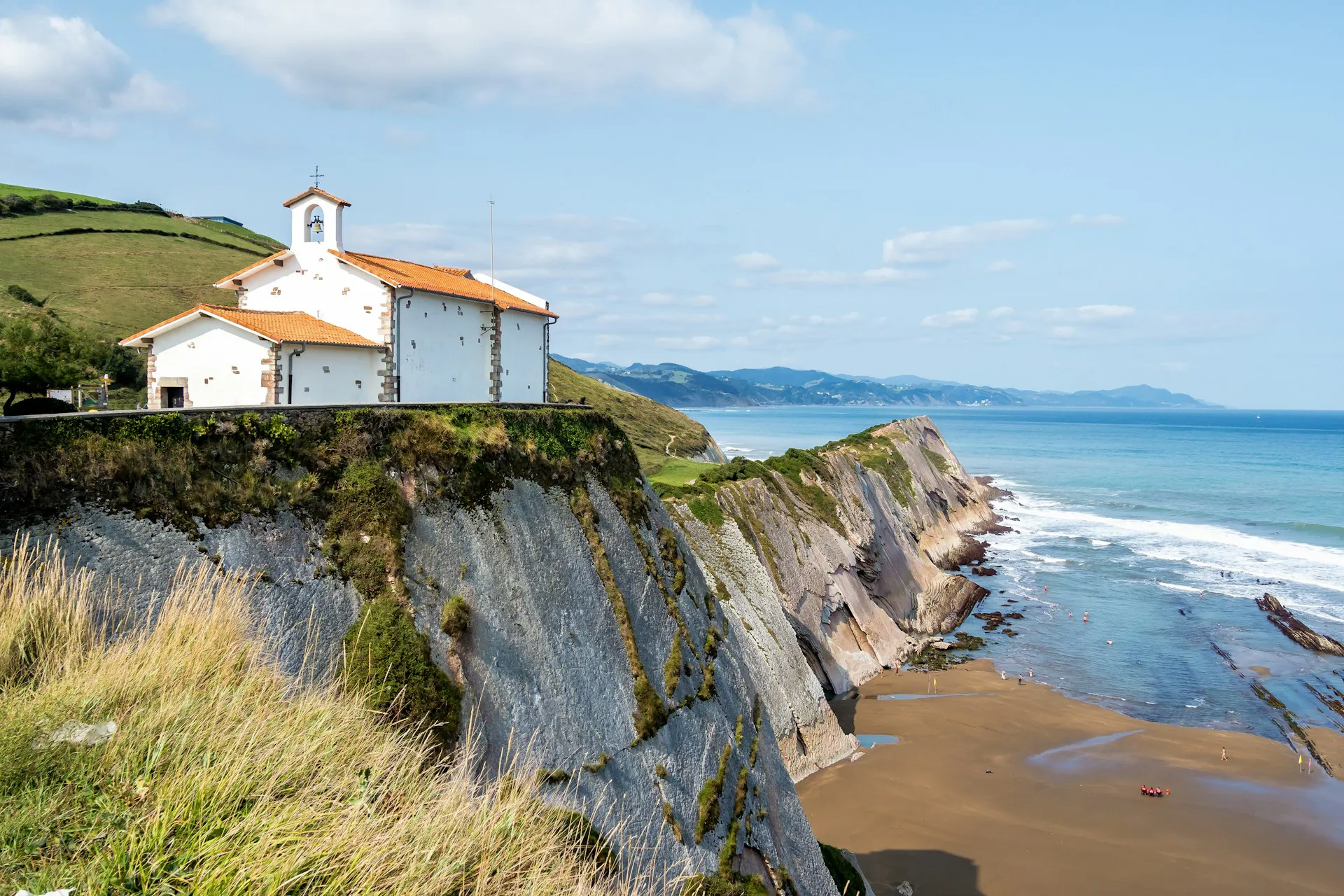 Church on a hill overlooking the seaside in the Basque Country wine region in Spain