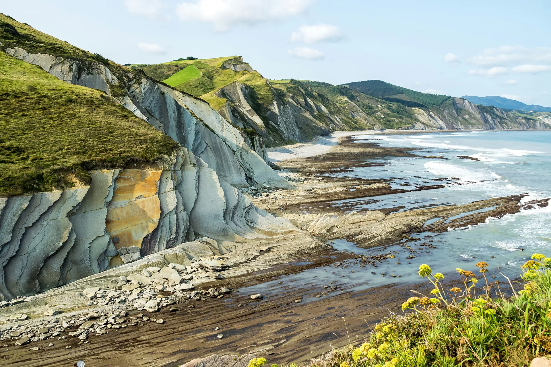 Green and grey cliffs overlooking the sea in the Basque Country wine region in Spain